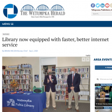 Thumbnail Image of 2 men standing in library.