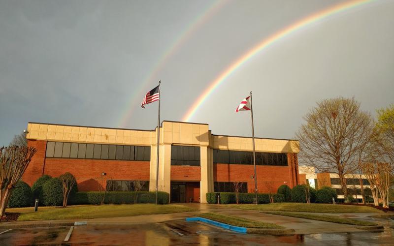 Alabama Supercomputer Center building front with double rainbow in sky above