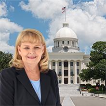 Photo of Linda Lupian with Alabama state capitol in background