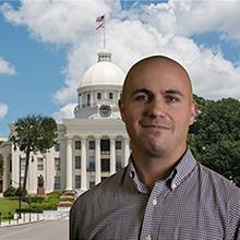 Photo of Weston Reed with Alabama state capitol in background