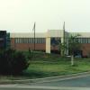 Front view of Alabama Supercomputer Center brick and stucko building with the Alabama Supercomputer Center sign in the foreground
